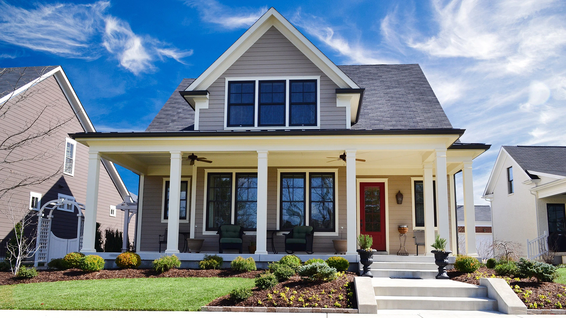 A home with a red door and neat landscaping in Quakertown, PA. 