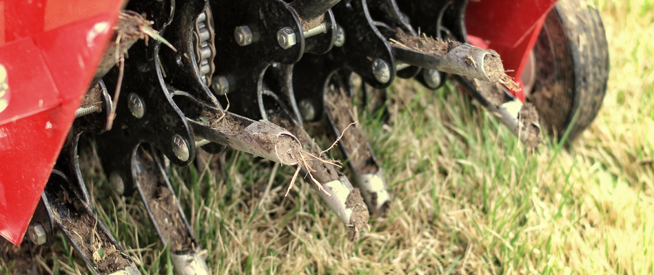 Close up on a red aeration machine at work on a property in Phoenixville, PA. 