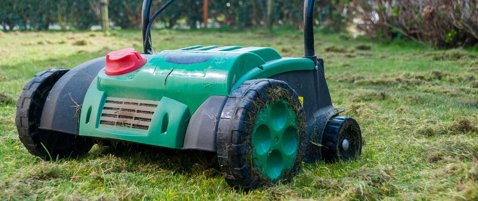 Close up on a green aerating machine in use on a property in Norristown, PA.